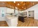Kitchen with wood ceiling, center island, stainless appliances, and plenty of natural light from multiple windows at 3002 Waterway Blvd, Isle of Palms, SC 29451