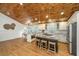Eat-in kitchen with wooden ceiling, center island, stainless appliances, and bright light fixture at 3002 Waterway Blvd, Isle of Palms, SC 29451