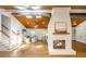 Bright open concept living room featuring hardwood floors, white painted brick fireplace and wood ceiling with skylights at 3002 Waterway Blvd, Isle of Palms, SC 29451