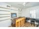 Spacious living room featuring built-in shelving, a ceiling fan, and hardwood flooring at 3002 Waterway Blvd, Isle of Palms, SC 29451