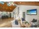 Bright open concept living room featuring hardwood floors, with a wood ceiling leading to a kitchen at 3002 Waterway Blvd, Isle of Palms, SC 29451