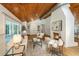 Cozy living room featuring a fireplace, wood ceiling, and lots of natural light at 3002 Waterway Blvd, Isle of Palms, SC 29451