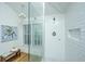 Elegant glass shower with white subway tile, hexagon tile floor, and a bright window at 3002 Waterway Blvd, Isle of Palms, SC 29451