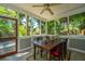 Inviting sunroom with a rustic dining table and serene views of lush greenery at 3002 Waterway Blvd, Isle of Palms, SC 29451