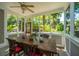 Charming sunroom with wood table and chairs, surrounded by large windows with outdoor views at 3002 Waterway Blvd, Isle of Palms, SC 29451