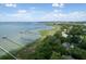 Aerial view of waterfront homes with private docks extending into the bay, surrounded by lush greenery at 320 Morrison Street, Mount Pleasant, SC 29464