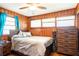 Cozy bedroom with wood-paneled walls, natural light, and ceiling fan at 320 Morrison Street, Mount Pleasant, SC 29464
