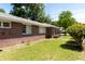 Well-maintained brick home featuring a lush green lawn and mature trees at 320 Morrison Street, Mount Pleasant, SC 29464