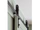 Detailed shot of a black sliding barn door mechanism at 338 Mcclellan Ave, McClellanville, SC 29458