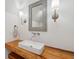 Stylish bathroom features a modern sink with wood countertop and decorative mirror at 338 Mcclellan Ave, McClellanville, SC 29458