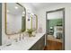 Bathroom boasts double vanity, gold framed mirrors, and a glimpse into a bedroom for a luxurious feel at 338 Mcclellan Ave, McClellanville, SC 29458