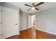 Bedroom with hardwood floors, ceiling fan, closet, and an ensuite bathroom with a double sink at 338 Mcclellan Ave, McClellanville, SC 29458