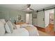 Relaxing bedroom with a ceiling fan, closet, ensuite bathroom, light green walls, and a comfortable bed at 338 Mcclellan Ave, McClellanville, SC 29458
