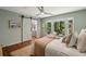 Bedroom showcasing a barn door leading to the bathroom, complemented by a large window and neutral decor at 338 Mcclellan Ave, McClellanville, SC 29458