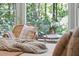 A cozy bedroom seating arrangement near the window with a plant at 338 Mcclellan Ave, McClellanville, SC 29458
