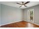 Relaxing bedroom with ceiling fan, wood floors and a screened in porch right outside the window at 338 Mcclellan Ave, McClellanville, SC 29458