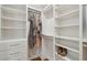 Walk in closet with custom shelves, drawers, hanging storage, and beautiful wood floors at 338 Mcclellan Ave, McClellanville, SC 29458