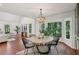 A dining space shows natural lighting, wood floors, updated light fixture, and neutral paint at 338 Mcclellan Ave, McClellanville, SC 29458