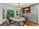 Bright dining area with large windows, wood flooring, and stylish seating with a decorative light at 338 Mcclellan Ave, McClellanville, SC 29458