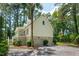 Exterior with an attached two-car garage and adjacent stairs to a balcony surrounded by green trees at 338 Mcclellan Ave, McClellanville, SC 29458