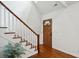 Inviting foyer with hardwood floors, white stairs and new wooden front door at 338 Mcclellan Ave, McClellanville, SC 29458