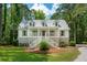 Charming two-story home with a welcoming front porch, gray shutters, and a well-manicured lawn at 338 Mcclellan Ave, McClellanville, SC 29458