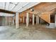 Unfinished garage features concrete floors, plywood ceiling and garage doors with automatic openers at 338 Mcclellan Ave, McClellanville, SC 29458