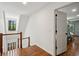 Hallway features wood floors and stairs leading to second floor with natural light at 338 Mcclellan Ave, McClellanville, SC 29458