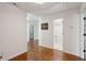 Hallway features hardwood floors, and doorways leading to multiple rooms and bathrooms at 338 Mcclellan Ave, McClellanville, SC 29458