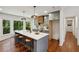Modern kitchen features a large island with seating, and views of the surrounding natural scenery at 338 Mcclellan Ave, McClellanville, SC 29458