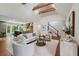 Open-concept living room and kitchen area with wood floors, vaulted ceiling, and modern decor at 338 Mcclellan Ave, McClellanville, SC 29458