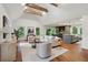 Bright, open-concept living room with exposed beams and seamless flow to the modern kitchen at 338 Mcclellan Ave, McClellanville, SC 29458