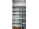 Image of a set of empty gray shelves over a wooden floor at 338 Mcclellan Ave, McClellanville, SC 29458
