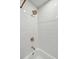 Shower with subway tile surround and gold colored fixtures at 338 Mcclellan Ave, McClellanville, SC 29458