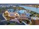 Stunning aerial view of a community clubhouse, pool, and serene lake surrounded by beautiful homes at 360 Parish Farms Dr, Summerville, SC 29486