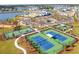 Overhead view showcasing tennis and basketball courts, a playground, and a community pool next to a tranquil lake at 360 Parish Farms Dr, Summerville, SC 29486