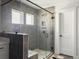 Elegant tiled shower with glass surround, bench, and modern fixtures next to vanity, and a doorway at 360 Parish Farms Dr, Summerville, SC 29486