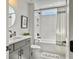 Modern bathroom features a shower-tub combo, gray vanity, and sleek black fixtures at 360 Parish Farms Dr, Summerville, SC 29486