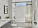 Modern bathroom features a shower-tub combo, gray vanity, and sleek black fixtures at 360 Parish Farms Dr, Summerville, SC 29486