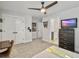 Spacious bedroom featuring a ceiling fan, neutral walls, a TV on the dresser and an adjacent bathroom at 360 Parish Farms Dr, Summerville, SC 29486