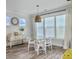 Bright dining room features a glass table, four chairs, large windows, and natural light at 360 Parish Farms Dr, Summerville, SC 29486