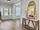 Bright foyer features white trim, a wood-look floor, console table and decorative mirror at 360 Parish Farms Dr, Summerville, SC 29486