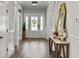 Bright foyer features white trim, a wood-look floor, console table and decorative mirror at 360 Parish Farms Dr, Summerville, SC 29486