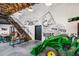 Unique interior design featuring farm-fresh motif, a tractor and a staircase leading to a lofted area at 360 Parish Farms Dr, Summerville, SC 29486