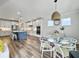 Bright kitchen and dining area with stainless appliances, shaker cabinets, large windows and modern light fixtures at 360 Parish Farms Dr, Summerville, SC 29486