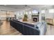 Open concept living room features hardwood floors, a grey fireplace, and a comfortable grey sectional sofa at 360 Parish Farms Dr, Summerville, SC 29486