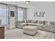 Spacious playroom with a large sectional sofa, ottoman, and bright natural light at 360 Parish Farms Dr, Summerville, SC 29486