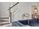 A staircase with white risers, a dark wood banister, and a table with a decorative mirror at 360 Parish Farms Dr, Summerville, SC 29486