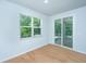Bedroom includes hardwood floors, bright windows, and sliding door to a screened porch at 3745 Sawmill Ct, Mount Pleasant, SC 29429