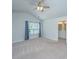 Carpeted bedroom with an ensuite bathroom and a window with sheer curtains at 3745 Sawmill Ct, Mount Pleasant, SC 29429
